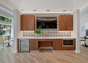 Thumbnail 10 of 40 - a kitchen with wooden cabinets and a counter top with a television