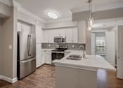 Thumbnail 22 of 40 - a white kitchen with stainless steel appliances and a white counter top