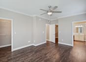 Thumbnail 26 of 40 - an empty living room with a ceiling fan and a closet