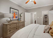 Thumbnail 35 of 40 - a bedroom with a large bed and a dresser