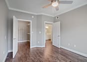 Thumbnail 27 of 40 - an empty living room with wood floors and a ceiling fan