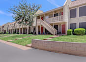 Thumbnail 1 of 37 - a street view of a row of apartments with grass and trees