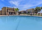 Thumbnail 2 of 37 - a swimming pool in front of a building with apartments in the background