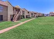 Thumbnail 13 of 37 - a row of houses with stairs and green grass