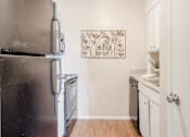 Thumbnail 20 of 37 - a kitchen with a refrigerator and a stove and a sink