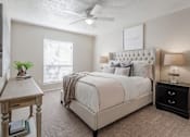 Thumbnail 27 of 37 - a bedroom with a bed and a ceiling fan