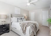 Thumbnail 28 of 37 - a white bedroom with a bed and a ceiling fan