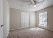 Thumbnail 35 of 37 - a bedroom with a ceiling fan and a window