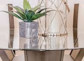 Thumbnail 25 of 37 - a potted plant sitting on top of a glass table