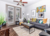 Thumbnail 46 of 48 - a living room with a couch and a ceiling fan