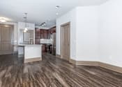 Thumbnail 26 of 48 - a renovated living room and kitchen with white walls and wood floors