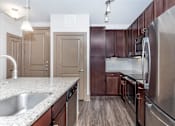 Thumbnail 27 of 48 - a kitchen with stainless steel appliances and granite counter tops