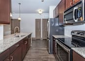 Thumbnail 34 of 48 - a kitchen with stainless steel appliances and granite counter tops