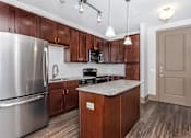 Thumbnail 19 of 48 - a kitchen with stainless steel appliances and wooden cabinets
