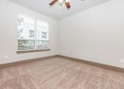 Thumbnail 41 of 48 - a living room with a large window and carpet