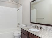 Thumbnail 20 of 48 - a bathroom with a sink toilet and shower and a mirror