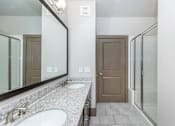 Thumbnail 28 of 48 - a bathroom with two sinks and a mirror and a shower
