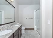 Thumbnail 36 of 48 - a bathroom with two sinks and a shower and a toilet