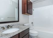 Thumbnail 37 of 48 - a bathroom with a sink toilet and a mirror