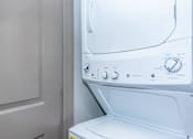 Thumbnail 21 of 48 - a washer and dryer in a laundry room with a white door