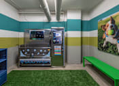 Thumbnail 16 of 48 - a dog wash room with a vending machine and a green bench