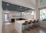 Thumbnail 17 of 54 - a kitchen with a white counter and chairs