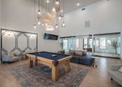 Thumbnail 20 of 54 - a living room with a pool table in the center