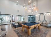 Thumbnail 15 of 54 - a living room with a pool table in the middle