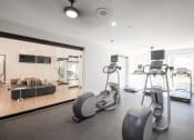 Thumbnail 27 of 54 - the gym is equipped with cardio equipment and a large mirror