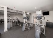 Thumbnail 25 of 54 - a gym with weights and cardio equipment in a building