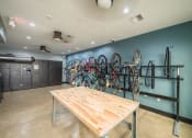 Thumbnail 31 of 54 - a room with a table and bikes on the wall
