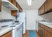 Thumbnail 20 of 43 - a kitchen with white appliances and wooden cabinets