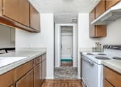 Thumbnail 21 of 43 - an empty kitchen with white appliances and wooden cabinets