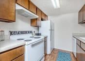 Thumbnail 22 of 43 - a kitchen with white appliances and wooden cabinets