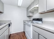 Thumbnail 36 of 43 - a kitchen with white appliances and white cabinets