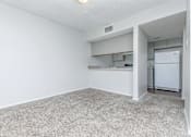 Thumbnail 37 of 43 - A white room with a carpeted floor and a white refrigerator in the corner.