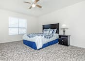 Thumbnail 26 of 43 - a bedroom with a bed and a ceiling fan