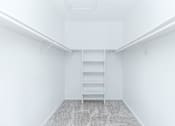 Thumbnail 38 of 43 - an empty room with white walls and a closet with shelves