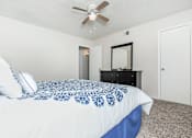 Thumbnail 27 of 43 - a bedroom with a large bed and a ceiling fan