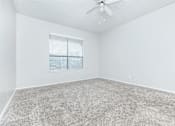 Thumbnail 41 of 43 - A room with a carpeted floor and a ceiling fan.