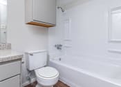 Thumbnail 42 of 43 - a bathroom with a toilet and a tub and a sink