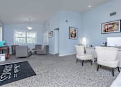 Thumbnail 8 of 43 - a living room with blue walls and white furniture