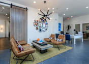 Thumbnail 13 of 34 - A living room with a brown chair and a blue chair.