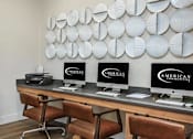 Thumbnail 17 of 34 - A modern office with American Business monitors on the desks.