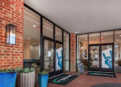 Thumbnail 19 of 34 - A building entrance with a glass door and a handprint on the glass.