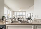 Thumbnail 21 of 34 - A modern kitchen with a double sink and a stove top oven.