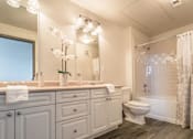 Thumbnail 33 of 34 - A bathroom with a white toilet and a white bathtub.