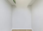 Thumbnail 45 of 54 - an empty room with white walls and a plant in the corner