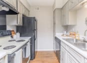 Thumbnail 38 of 54 - a kitchen with white cabinets and a sink and a refrigerator