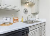Thumbnail 39 of 54 - a kitchen with white cabinets and a sink
